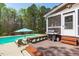 Backyard features a pool, deck, built-in bench, grilling area and outdoor furniture perfect for entertaining at 2909 Timpani Trl, Apex, NC 27539