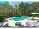 Relaxing pool area features a diving board, lounging chairs and lush landscaping for a tranquil outdoor space at 2909 Timpani Trl, Apex, NC 27539