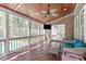 Cozy screened porch with wood ceiling and floors, comfortable seating, and views of the pool and yard at 2909 Timpani Trl, Apex, NC 27539