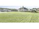 Community amenities featuring playground, pool house, and large grassy recreation area at 293 Providence Creek Dr, Fuquay Varina, NC 27526