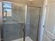 Modern shower with glass doors, gray tile, and safety bars at 293 Providence Creek Dr, Fuquay Varina, NC 27526