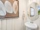 Stylish powder room with a modern sink, decorative mirror, and a neutral color palette at 293 Providence Creek Dr, Fuquay Varina, NC 27526