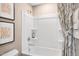 Bathroom with a tub/shower combination featuring clean, white fixtures and a decorative shower curtain at 293 Providence Creek Dr, Fuquay Varina, NC 27526