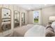 Charming bedroom with natural light, paneled walls, and stylish mirrors for a relaxing retreat at 293 Providence Creek Dr, Fuquay Varina, NC 27526
