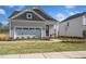Charming home featuring a brick pathway, two-car garage, and a welcoming front porch area at 293 Providence Creek Dr, Fuquay Varina, NC 27526