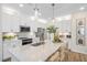 Modern kitchen featuring white cabinets, stainless steel appliances, a large island, and pendant lighting at 293 Providence Creek Dr, Fuquay Varina, NC 27526