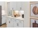 Kitchen featuring white cabinets, stainless steel appliances and quartz countertops at 293 Providence Creek Dr, Fuquay Varina, NC 27526