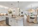 Spacious kitchen with a large island, pendant lighting, and open layout to dining and living area at 293 Providence Creek Dr, Fuquay Varina, NC 27526