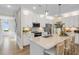 Modern kitchen featuring white cabinets, stainless steel appliances, a large island, and pendant lighting at 293 Providence Creek Dr, Fuquay Varina, NC 27526