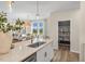 Bright kitchen features stainless steel appliances, an island with a sink, and a view to the living room at 293 Providence Creek Dr, Fuquay Varina, NC 27526