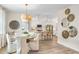 Open dining and kitchen area with an island, modern appliances, and bright natural light at 293 Providence Creek Dr, Fuquay Varina, NC 27526