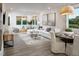Open-concept living and dining area showcasing a comfortable white sofa and round dining table at 293 Providence Creek Dr, Fuquay Varina, NC 27526
