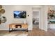 Inviting living room with wood floors, modern console, and an open view to the bedroom at 293 Providence Creek Dr, Fuquay Varina, NC 27526
