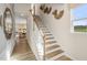 Elegant staircase with wood treads, white risers, and decorative wall art at 293 Providence Creek Dr, Fuquay Varina, NC 27526