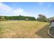 Expansive backyard with a fence and mature trees and shrubs at 2936 Turning Brook Ln, Raleigh, NC 27616
