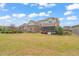 Expansive backyard with well-maintained lawn and a screened porch at 2936 Turning Brook Ln, Raleigh, NC 27616