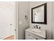 Stylish bathroom featuring a modern vanity, granite countertop, and decorative mirror at 2936 Turning Brook Ln, Raleigh, NC 27616