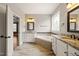 Bright bathroom with soaking tub, double vanity, granite countertop, and tile floors at 2936 Turning Brook Ln, Raleigh, NC 27616