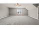 The spacious bedroom offers neutral walls, grey carpet, and a window that allows natural light at 2936 Turning Brook Ln, Raleigh, NC 27616