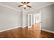 Bedroom with hardwood floors, natural light, and views of an adjoining room at 2936 Turning Brook Ln, Raleigh, NC 27616