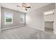 Bright bedroom featuring neutral walls, plush carpeting, and a walk-in closet for ample storage at 2936 Turning Brook Ln, Raleigh, NC 27616