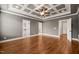 Spacious bedroom with coffered ceiling, hardwood floors, and walk-in closets at 2936 Turning Brook Ln, Raleigh, NC 27616