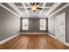 Bedroom with hardwood floors, coffered ceiling, recessed lights, and natural light at 2936 Turning Brook Ln, Raleigh, NC 27616