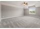 Bright bedroom with neutral walls, plush carpeting, ceiling fan and natural light from the window at 2936 Turning Brook Ln, Raleigh, NC 27616