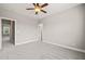 This bedroom features neutral walls, grey carpet, and entrances to other rooms and closets at 2936 Turning Brook Ln, Raleigh, NC 27616