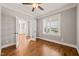 Bright bedroom with hardwood floors, a ceiling fan, and an adjoining doorway at 2936 Turning Brook Ln, Raleigh, NC 27616