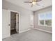 The bedroom features neutral walls, grey carpet, a ceiling fan, and windows that allow natural light at 2936 Turning Brook Ln, Raleigh, NC 27616