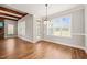 Bright dining space with hardwood floors and natural light from large windows at 2936 Turning Brook Ln, Raleigh, NC 27616