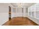 Formal dining room with wainscoting, hardwood floors, and a decorative chandelier at 2936 Turning Brook Ln, Raleigh, NC 27616