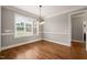 Hardwood floored dining area with neutral paint, classic lighting, and natural light at 2936 Turning Brook Ln, Raleigh, NC 27616