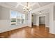 Bright dining room featuring wainscoting, hardwood floors and a view of the front yard at 2936 Turning Brook Ln, Raleigh, NC 27616