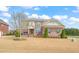 Beautiful two-story brick home featuring a manicured lawn and detailed architectural design at 2936 Turning Brook Ln, Raleigh, NC 27616