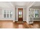 Elegant foyer with hardwood floors and natural light, featuring paneled doors at 2936 Turning Brook Ln, Raleigh, NC 27616