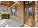 Close-up of the front porch with a wooden door and detailed brickwork at 2936 Turning Brook Ln, Raleigh, NC 27616