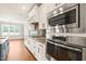 Modern kitchen featuring stainless steel appliances, granite counters, and white cabinetry at 2936 Turning Brook Ln, Raleigh, NC 27616
