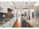 Modern kitchen with granite counters, stainless appliances, custom cabinets, and open layout at 2936 Turning Brook Ln, Raleigh, NC 27616