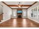 Bright living room with hardwood floors, exposed wood beams, and a stone fireplace with mounted TV at 2936 Turning Brook Ln, Raleigh, NC 27616