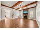 Spacious living room features wood beams, fireplace, hardwood floors, and ample natural light at 2936 Turning Brook Ln, Raleigh, NC 27616