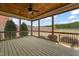Screened-in porch with wood flooring, a ceiling fan, and views of the backyard and foliage at 2936 Turning Brook Ln, Raleigh, NC 27616