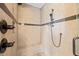 Tiled shower with seat, multiple shower heads, and soap niche at 2936 Turning Brook Ln, Raleigh, NC 27616