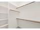 Walk-in closet featuring white shelving and wooden rods, offering ample storage space at 2936 Turning Brook Ln, Raleigh, NC 27616