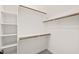This walk-in closet includes white shelving and wooden clothing rods for ample space and organization at 2936 Turning Brook Ln, Raleigh, NC 27616