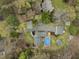 A high angle aerial shot of the property shows a pool, deck, and home with mature trees at 2949 Tram Rd, Fuquay Varina, NC 27526