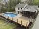 Aerial view showcasing the pool, deck, and screened porch of the beautiful property at 2949 Tram Rd, Fuquay Varina, NC 27526