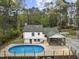Aerial view showcasing the pool, deck, and screened porch of the beautiful home at 2949 Tram Rd, Fuquay Varina, NC 27526