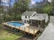 Aerial view showcasing the pool, deck, and screened porch of the charming property at 2949 Tram Rd, Fuquay Varina, NC 27526